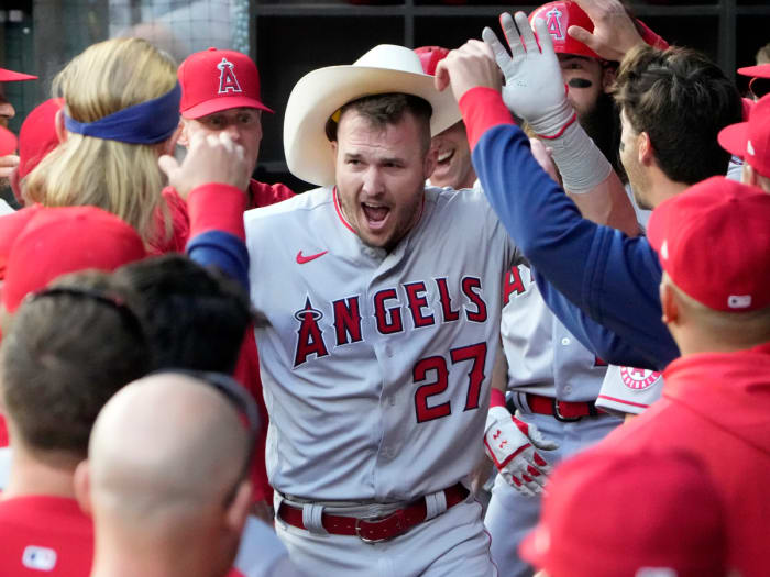 Apr 14, 2022; Arlington, Texas, USA; Los Angeles Angels center fielder Mike Trout (27) celebrates his home run with teammates in the dugout against the Texas Rangers during the first inning of a baseball game at Globe Life Field.